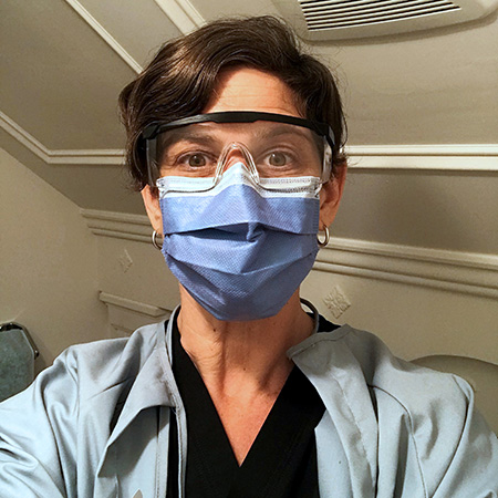 Midwife Elizabeth Brandeis in mask and goggles