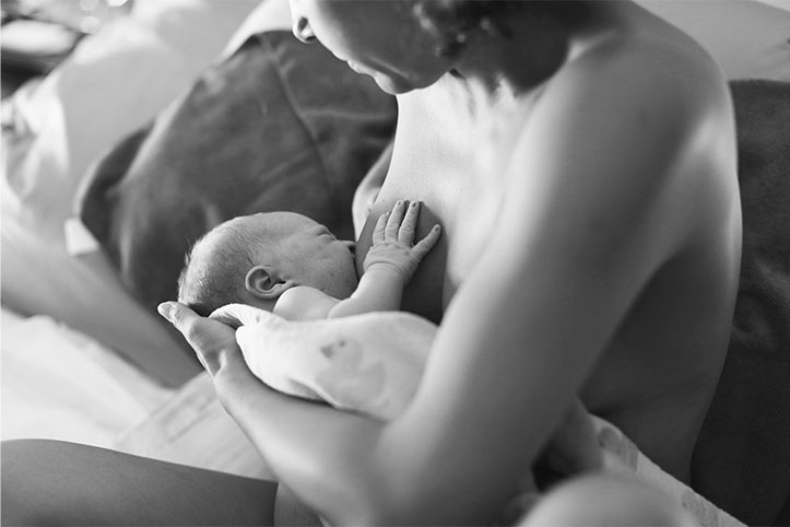 Photo of birthing person chest/breastfeeding.