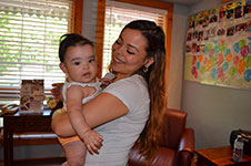 Photo of woman holding baby in Six Nations birth centre room.