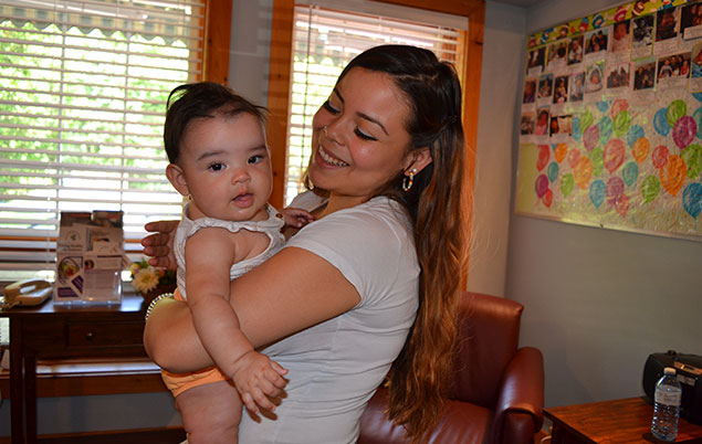 Photo of woman holding baby in Six Nations birth centre room..