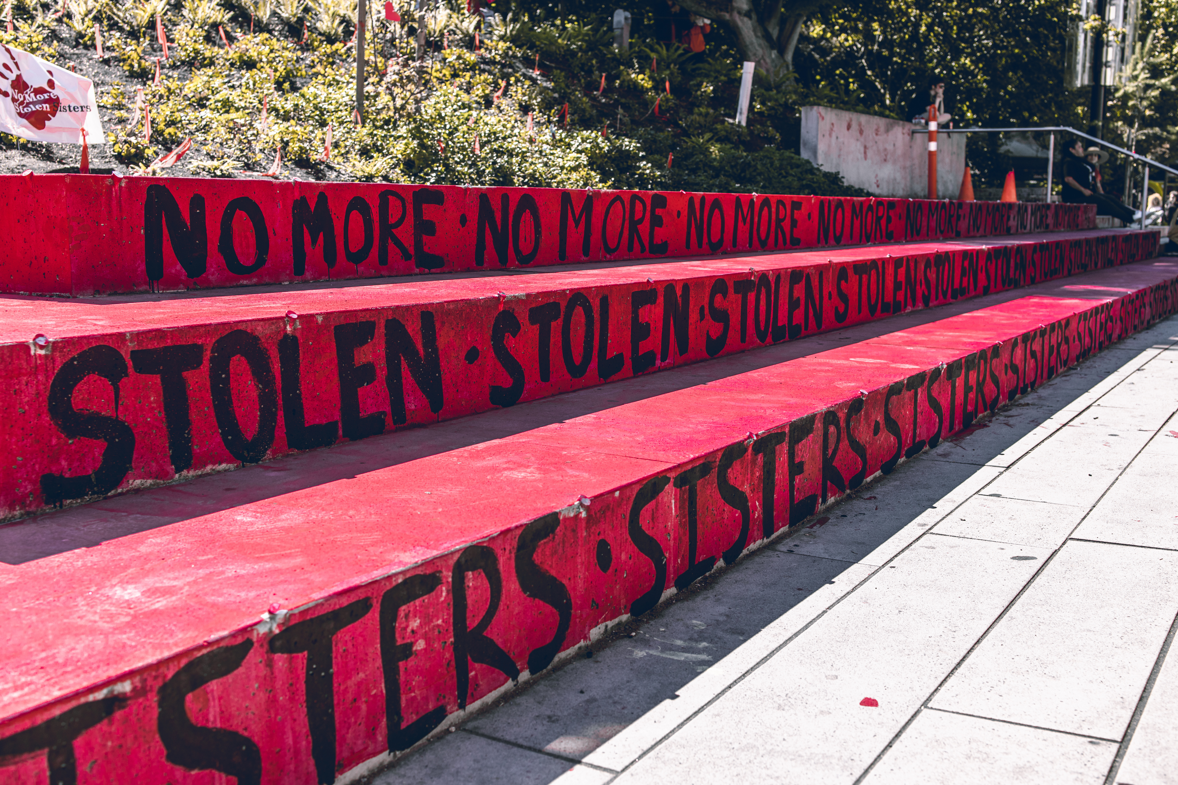 Steps painted red with text "No more stolen sisters" on the Robson Square Memorial to honour Missing and Murdered Indigenous Women in US and Canada