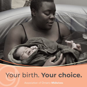 Woman in tub with newborn after water birth.